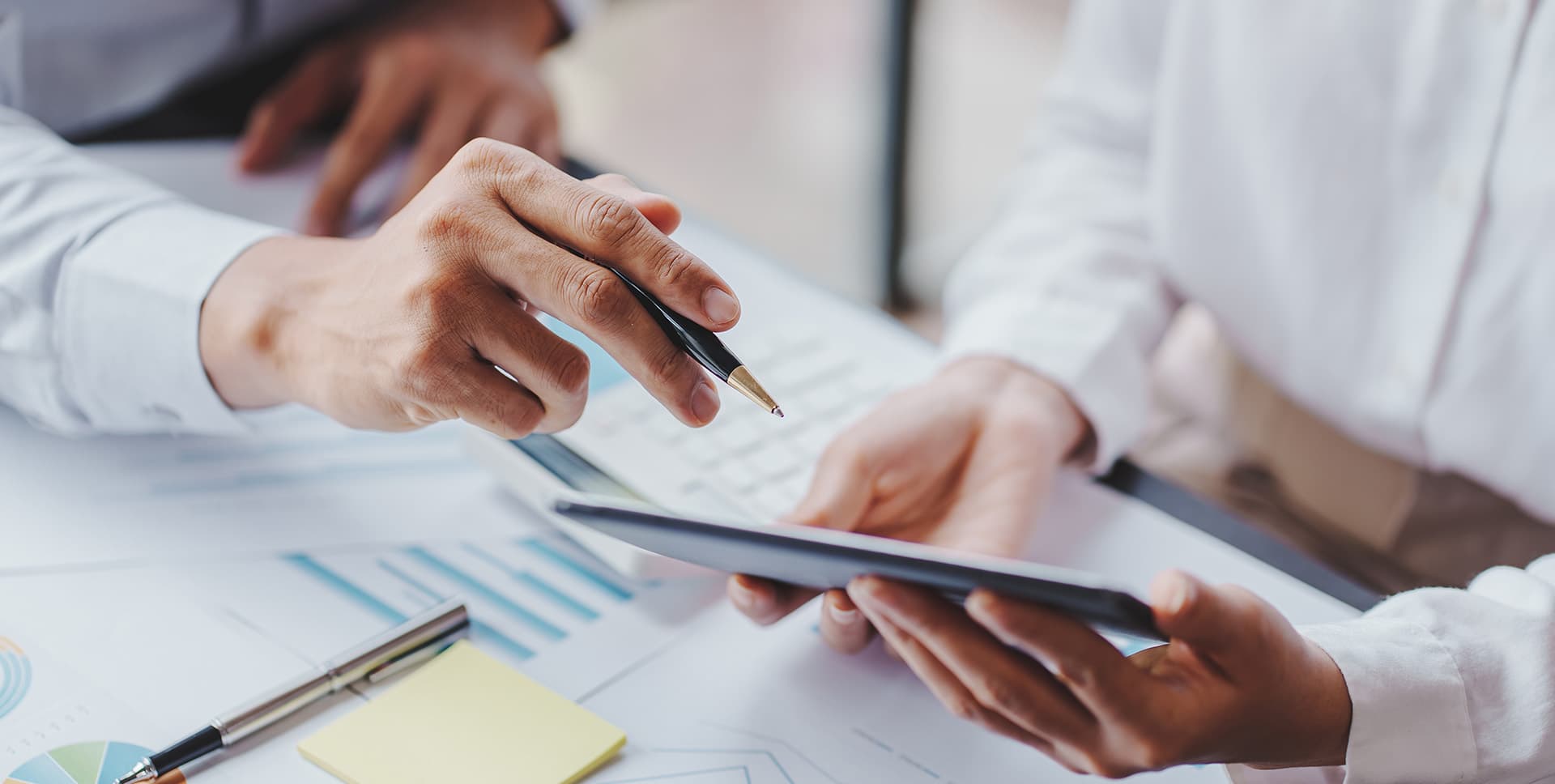 Close up of pharamacists looking at business plans on a tablet