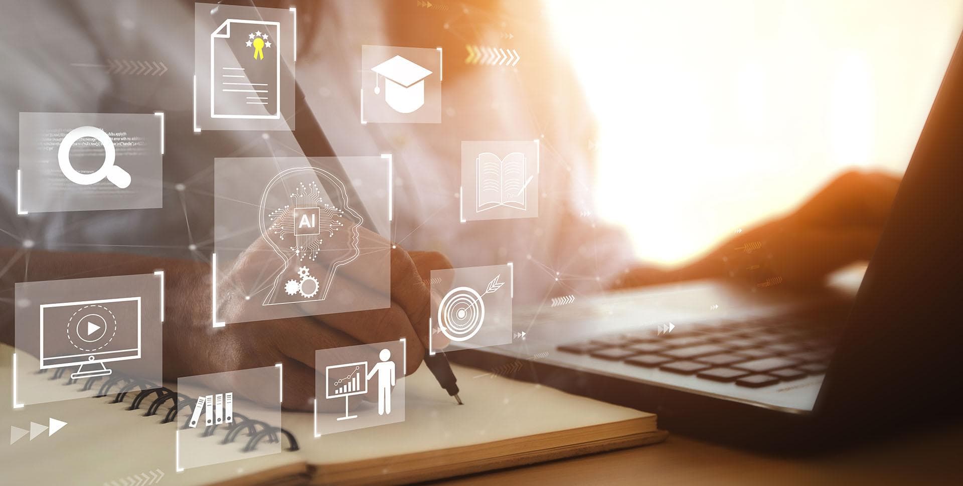 Person working in front of a laptop and a notebook with graphics layered over the image