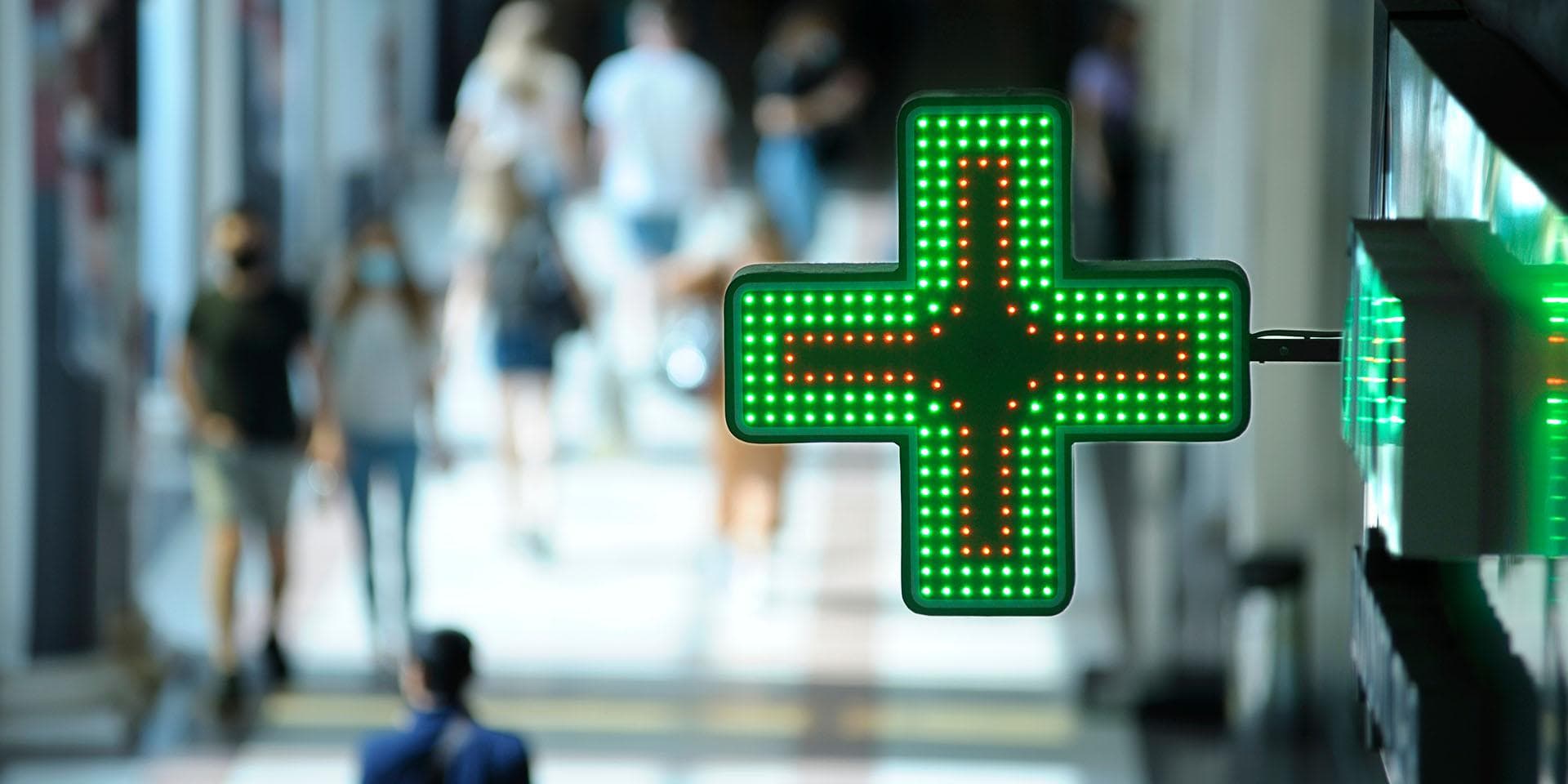 Close up of a pharmacist handing over medication to a customer