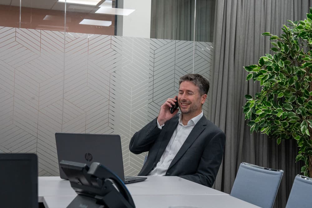 Paul Steet taking a phone call from a pharamacy seller client