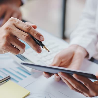 Close up of pharamacists looking at business plans on a tablet