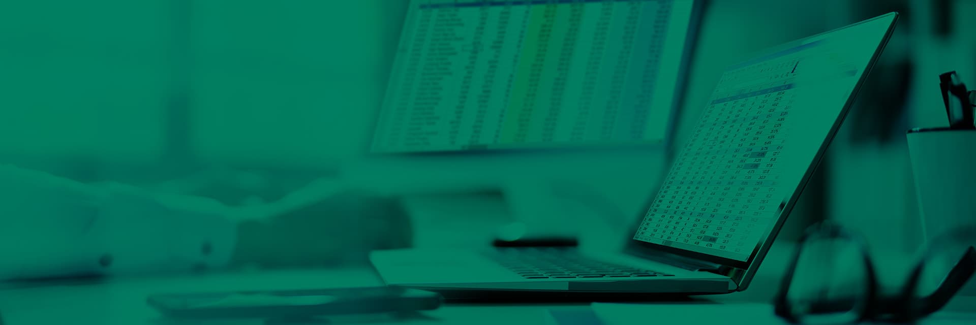 Green tinted image of a laptop with pharmacy performance figures